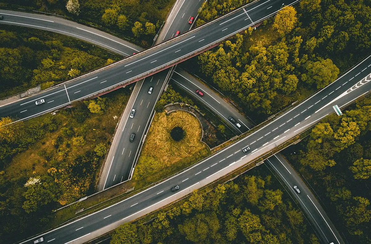 Aerial view of a highway interchange surrounded by trees